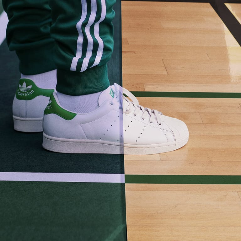 Superstans worn on foot, the frame split between tennis court and basketball court